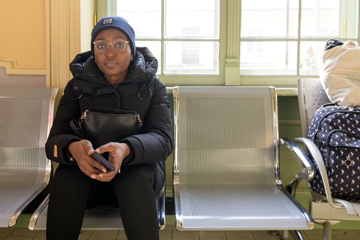 Grace*, a Nigerian national waits at a train station where refugees are being supported by local partners of DEC charities in early March 2022. Her daughter, a medical student, was detained at the Polish border. Image: Anthony Upton/DEC.